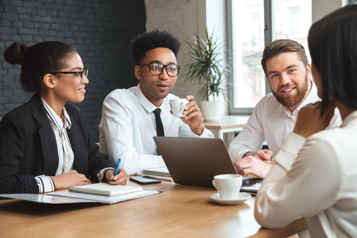 Modern office meeting space with financial charts and collaborative workspace