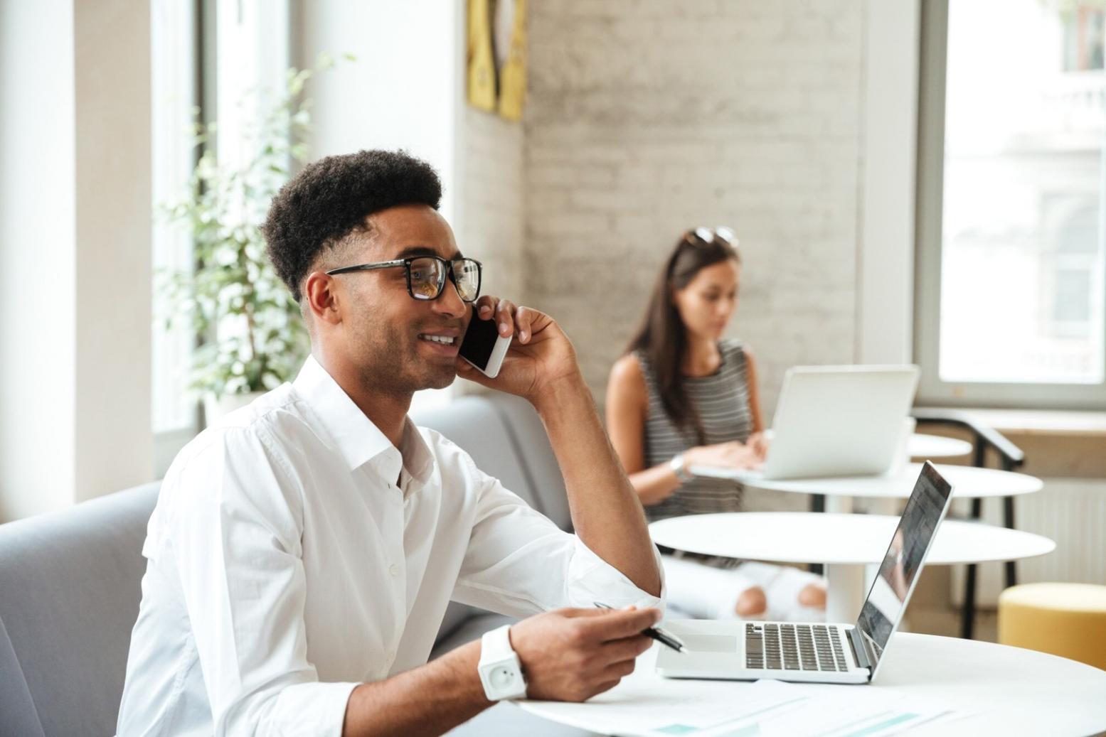 Financial planning consultation workspace with documents and laptop